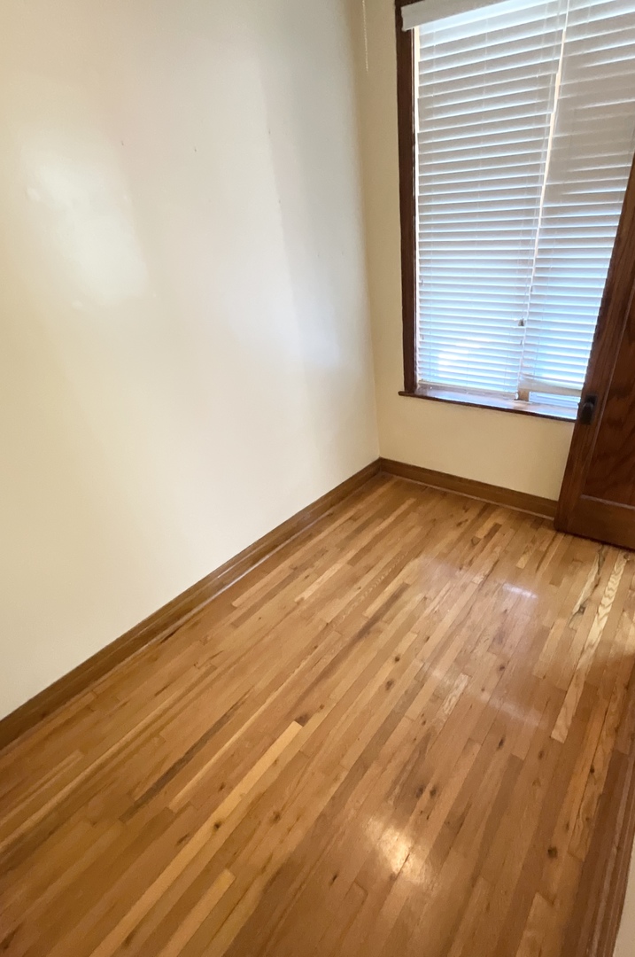 919 North Leavitt Street, Unit 2F Chicago, IL 60622 - Photo 14 of 18 a view of an empty room with wooden floor and a window