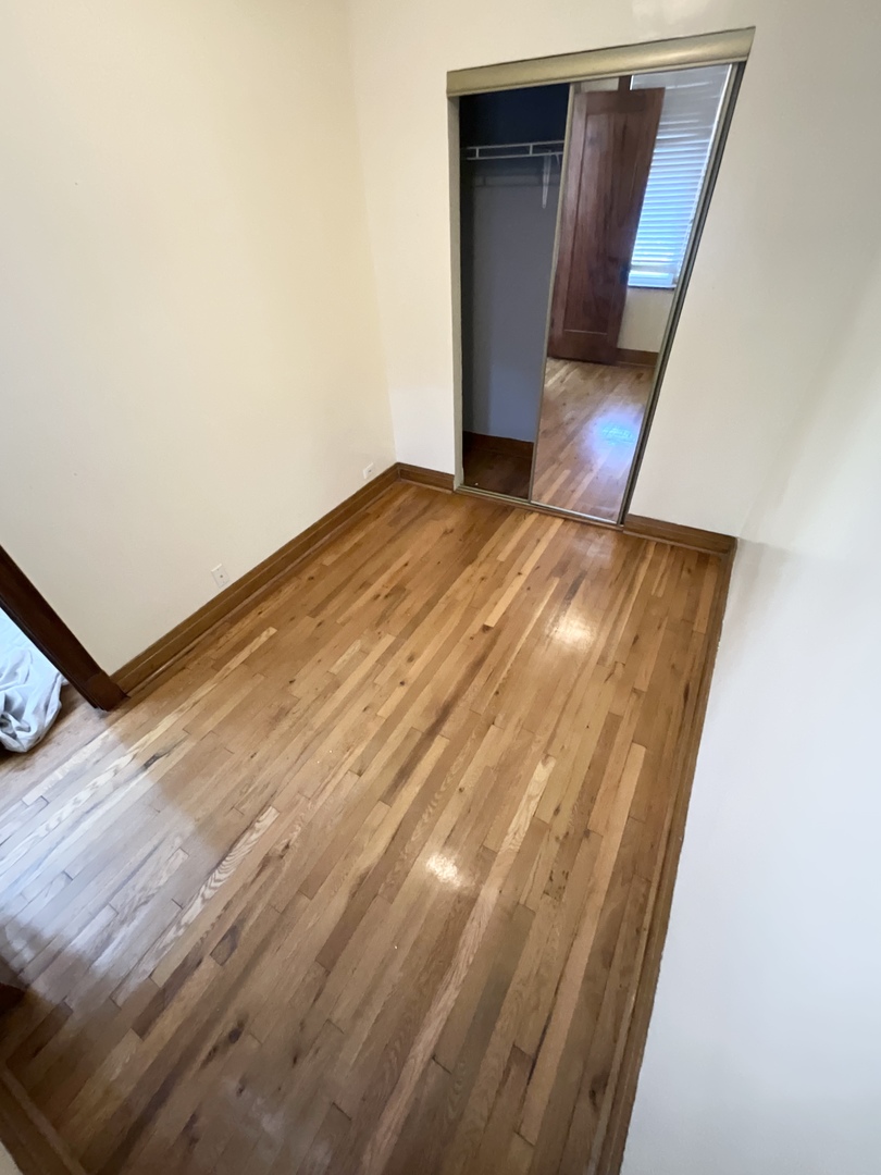 919 North Leavitt Street, Unit 2F Chicago, IL 60622 - Photo 15 of 18 a view of a hallway with wooden floor