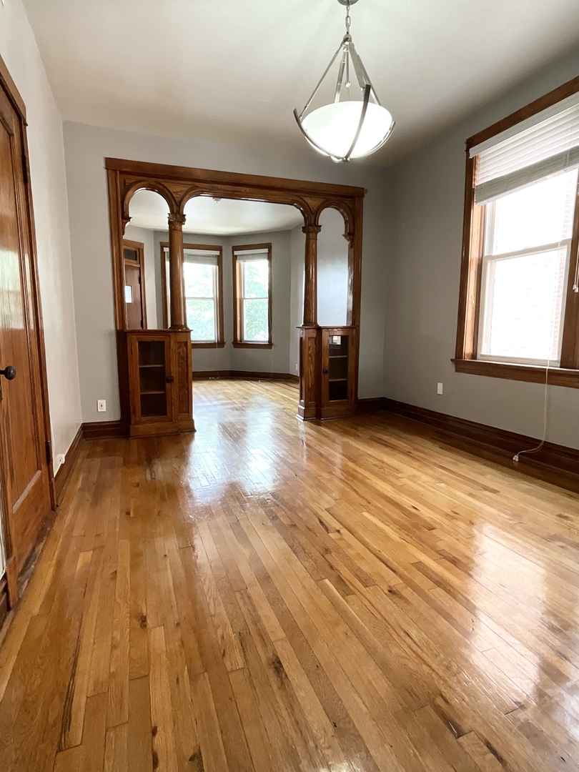 919 North Leavitt Street, Unit 2F Chicago, IL 60622 - Photo 2 of 18 a view of empty room with wooden floor and fan