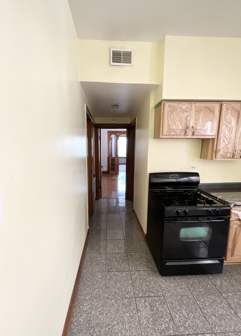 919 North Leavitt Street, Unit 2F Chicago, IL 60622 - Photo 7 of 18 a kitchen with a stove and a microwave