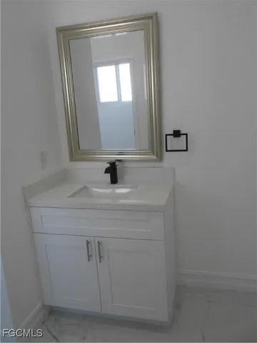 a bathroom with a sink and mirror