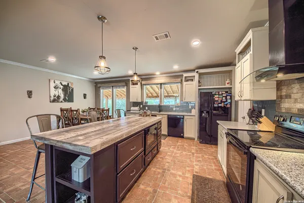 a kitchen with stainless steel appliances granite countertop a stove and a refrigerator
