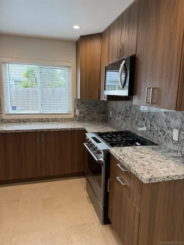 a kitchen with a stove a sink and a microwave