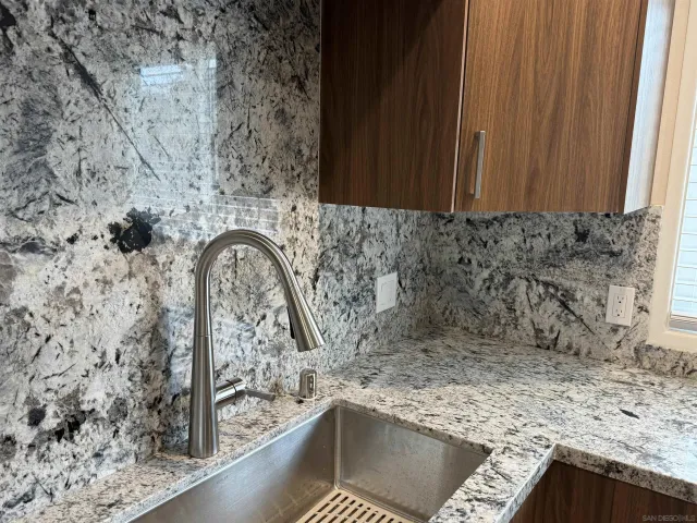 a view of a sink a microwave and a window