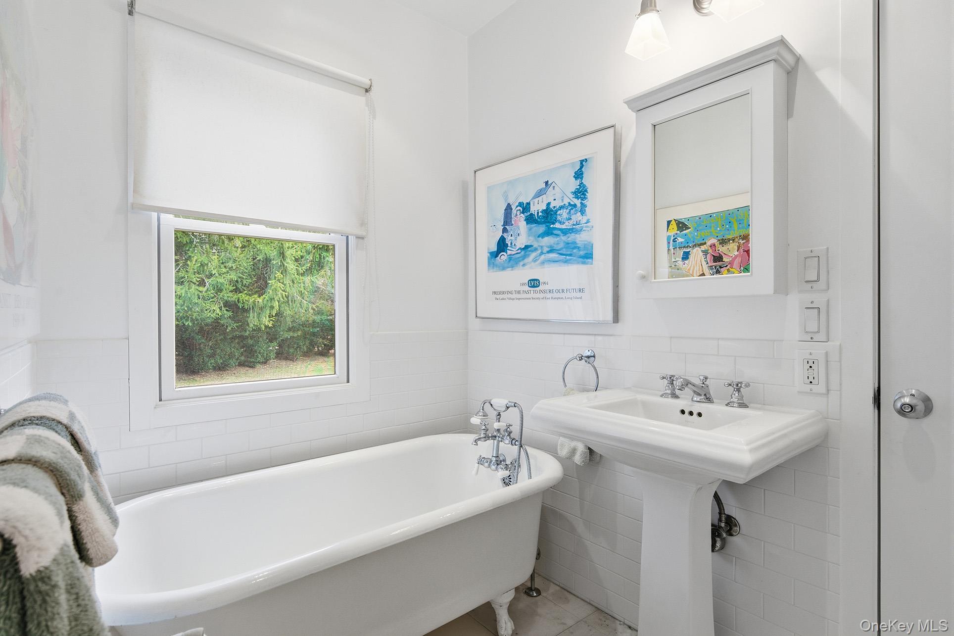 60 Skimhampton Road East Hampton, NY 11937 - Photo 24 of 37 a white bath tub sitting next to a white sink