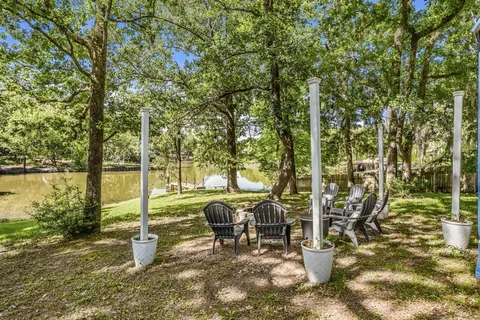 a view of a patio with table and chairs and floor to ceiling window