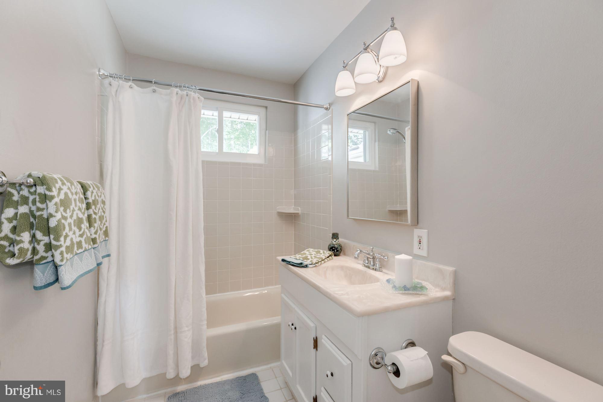 8425 Thames Street Springfield, VA 22151 - Photo 12 of 30 a bathroom with a sink a toilet and a mirror