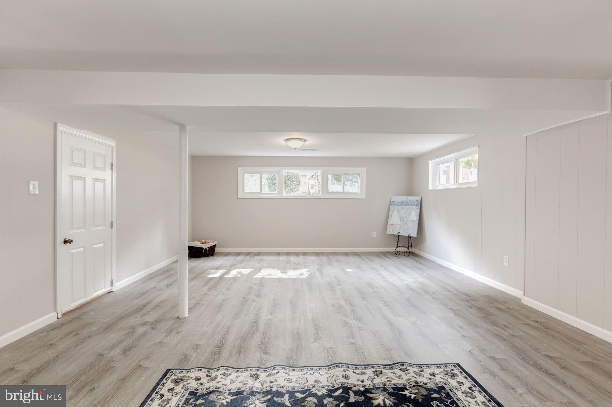 8425 Thames Street Springfield, VA 22151 - Photo 19 of 30 a view of an empty room with wooden floor and a window