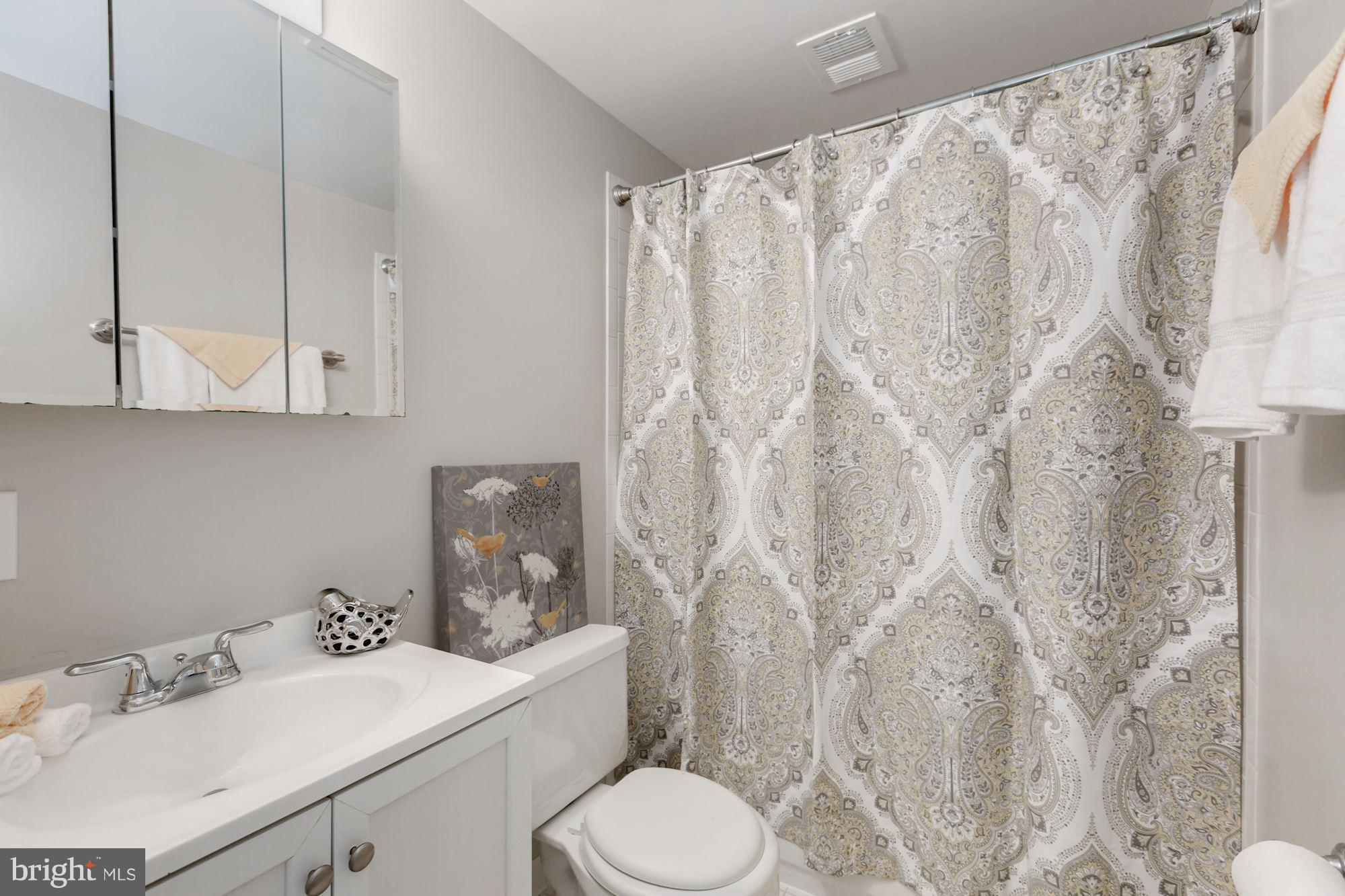 8425 Thames Street Springfield, VA 22151 - Photo 21 of 30 a bathroom with a sink toilet and shower