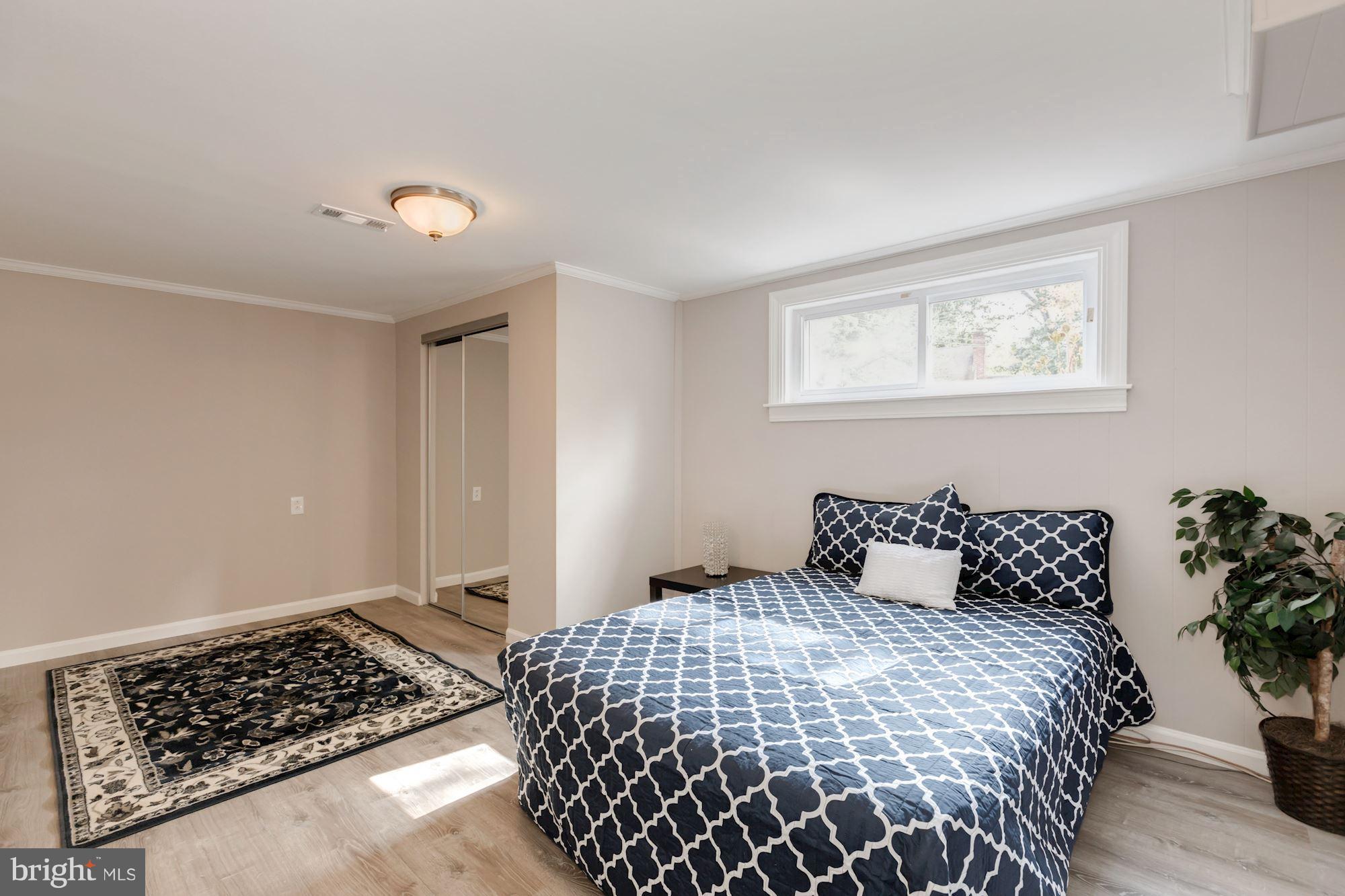 8425 Thames Street Springfield, VA 22151 - Photo 22 of 30 a bedroom with a bed and a potted plant