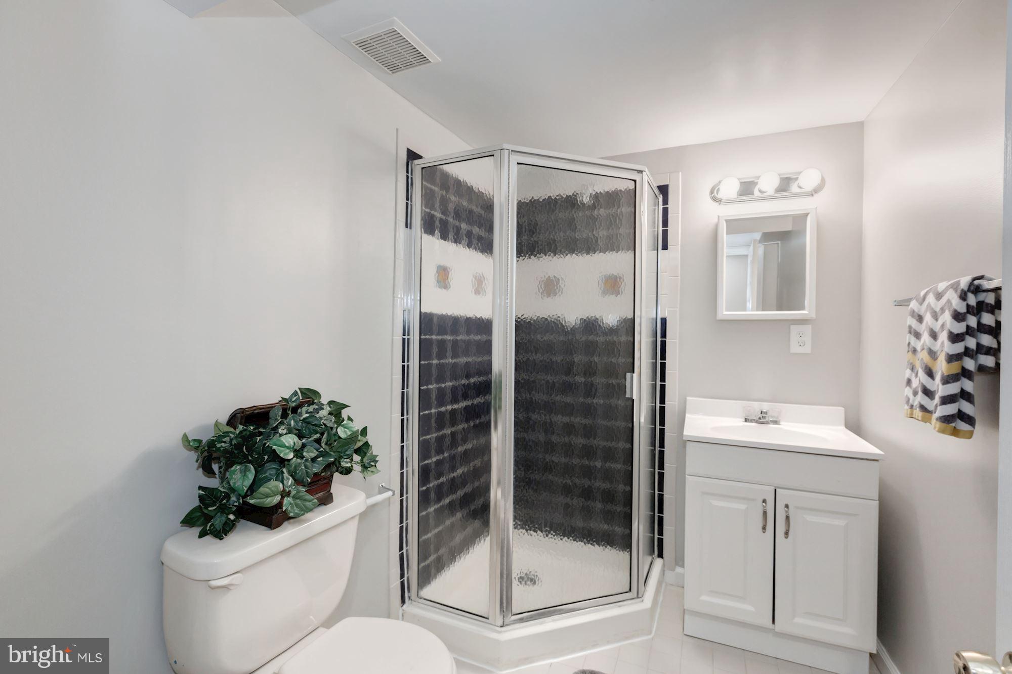 8425 Thames Street Springfield, VA 22151 - Photo 23 of 30 a bathroom with a toilet sink and shower