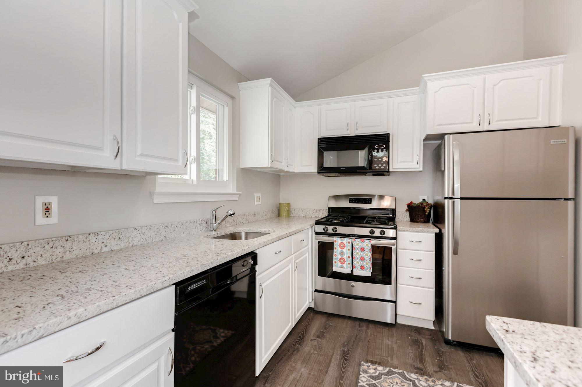 8425 Thames Street Springfield, VA 22151 - Photo 8 of 30 a kitchen with stainless steel appliances granite countertop a refrigerator stove a sink and dishwasher