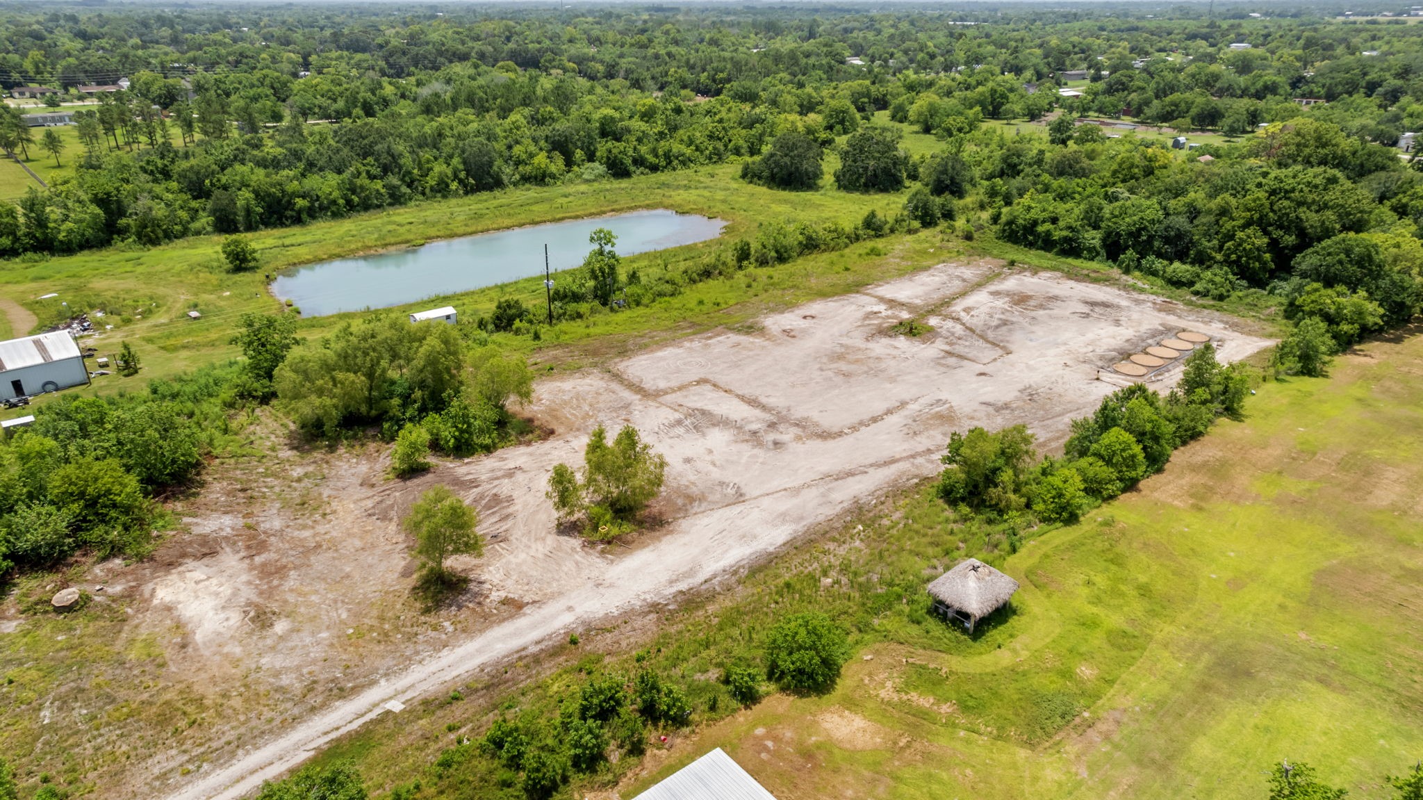 1403 Algoa-Friendswood Road Alvin, TX 77511 - Photo 16 of 21 an aerial view of green landscape with trees houses and mountain view