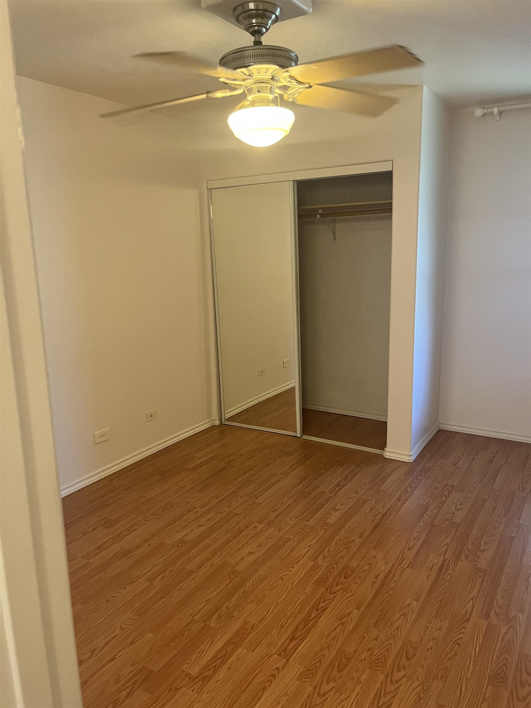 495 Liholiho Street, Unit 204 Wailuku, HI 96793 - Photo 13 of 42 a view of an empty room with closet and wooden floor