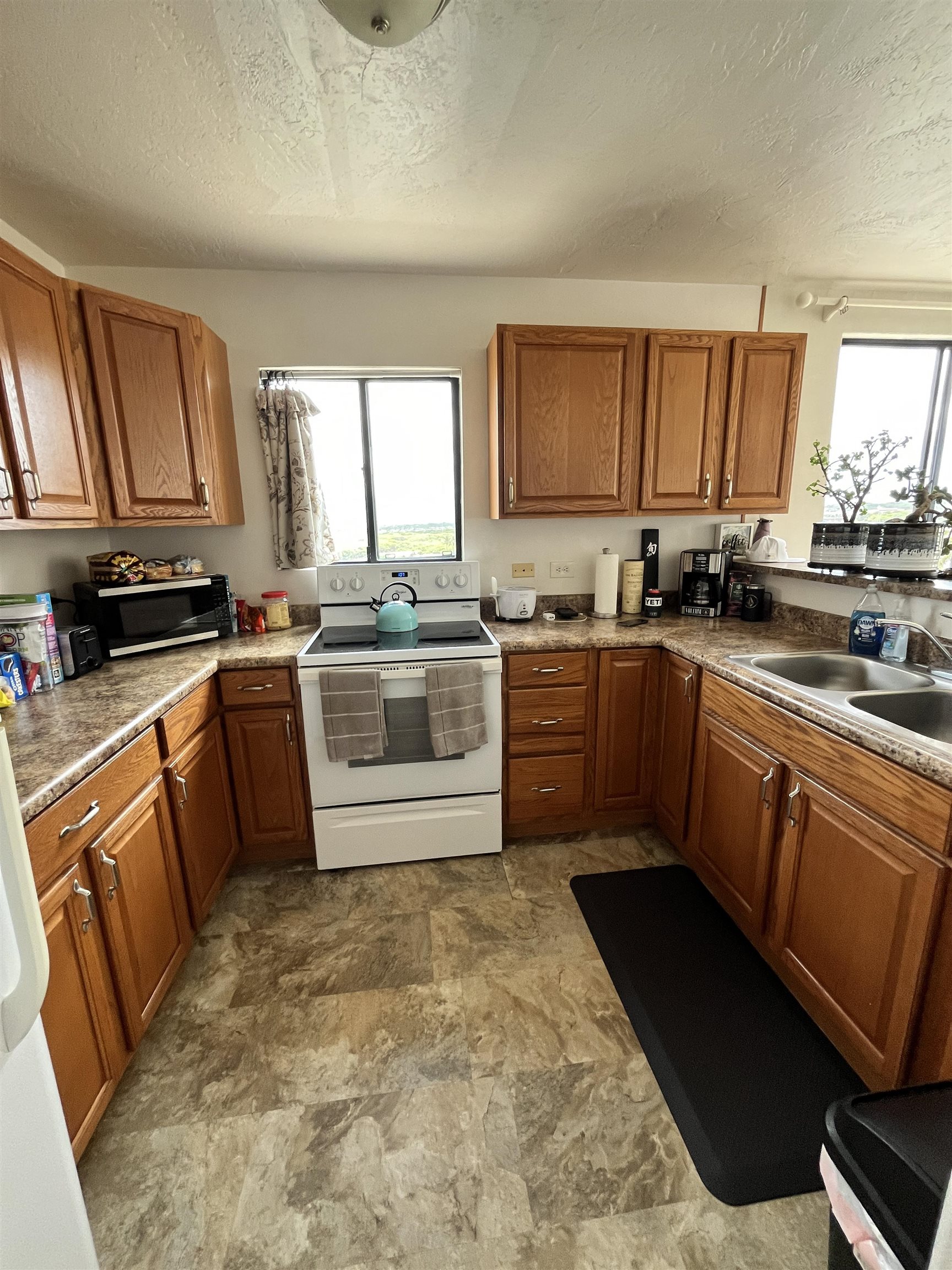 495 Liholiho Street, Unit 204 Wailuku, HI 96793 - Photo 2 of 42 a kitchen with stainless steel appliances granite countertop a sink a stove a refrigerator cabinets and a window