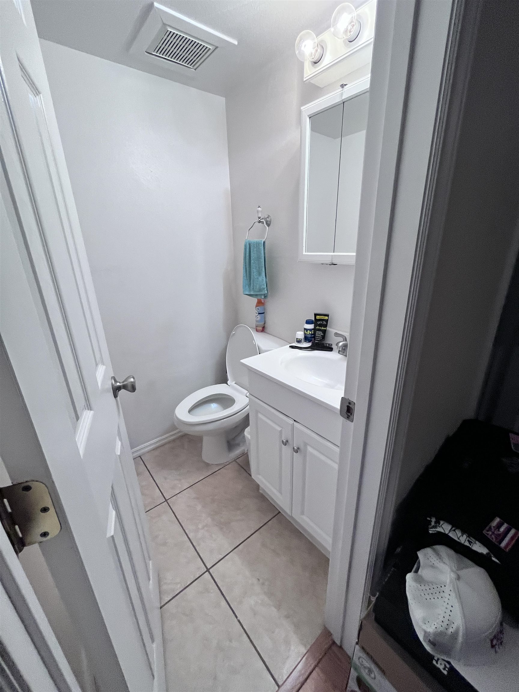 495 Liholiho Street, Unit 204 Wailuku, HI 96793 - Photo 37 of 42 a bathroom with a sink a toilet a mirror and shower curtain