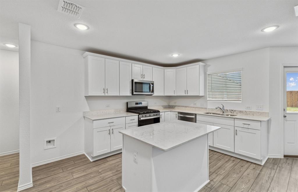 14058 Kempt Drive Pilot Point, TX 76258 - Photo 2 of 9 Spacious kitchen with eat-in bartop island