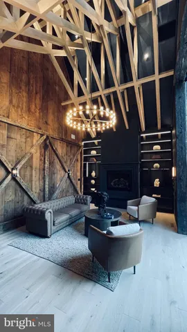 a living room with fireplace furniture and a large window