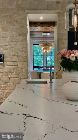 a view of water heater room with wooden floor