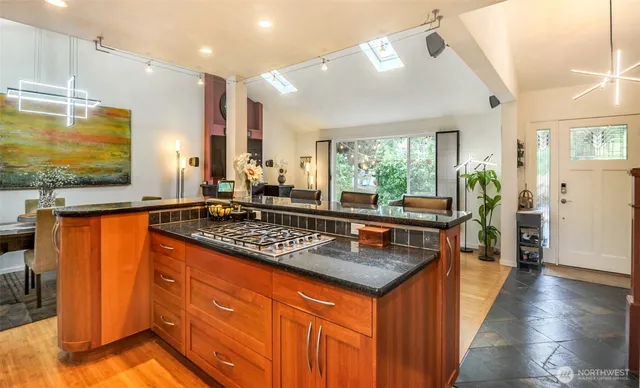 a room with a stove and a kitchen view