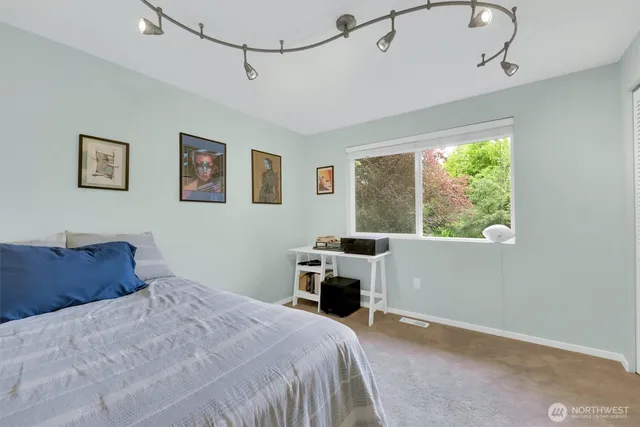 a view of a patio with table and chairs potted plants and a large tree