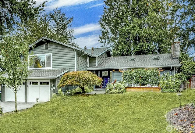 a view of backyard with outdoor seating and plants