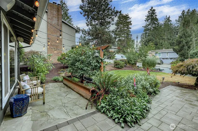 a kitchen with stainless steel appliances kitchen island granite countertop a stove and a sink