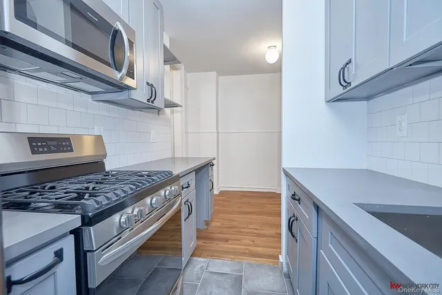 a kitchen with stainless steel appliances granite countertop a stove and a sink