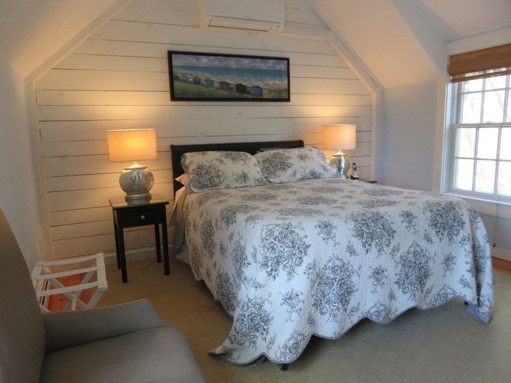 40 Brant Rock Road, Unit 40 Mashpee, MA 02649 - Photo 14 of 16 a bedroom with a bed and a lamp