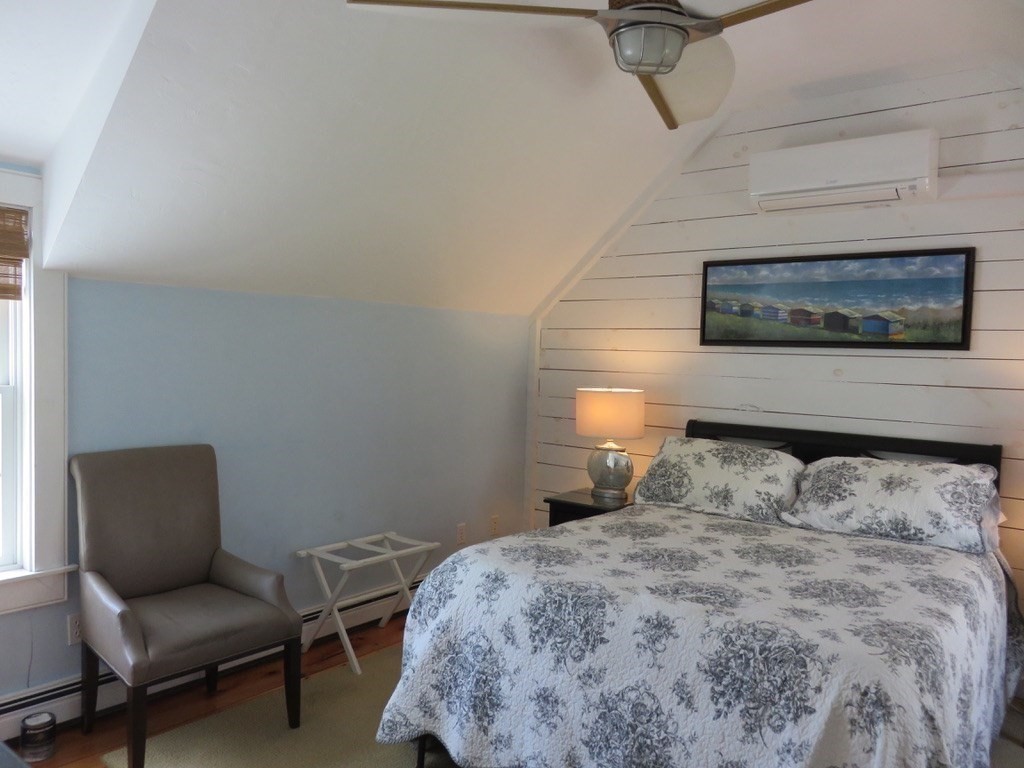40 Brant Rock Road, Unit 40 Mashpee, MA 02649 - Photo 15 of 16 a bedroom with a bed and a chair
