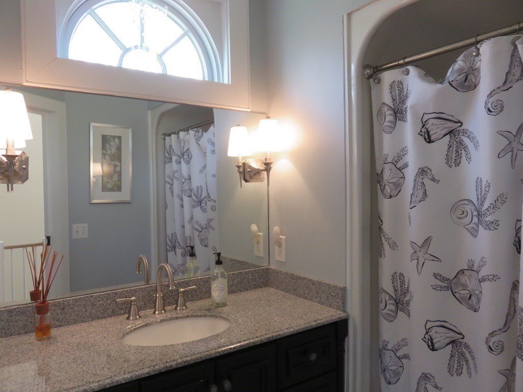 40 Brant Rock Road, Unit 40 Mashpee, MA 02649 - Photo 16 of 16 a bathroom with a sink and a mirror