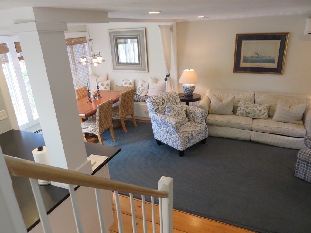 40 Brant Rock Road, Unit 40 Mashpee, MA 02649 - Photo 6 of 16 a living room with furniture and a table