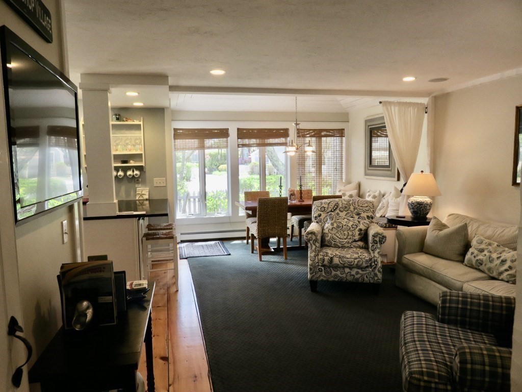 40 Brant Rock Road, Unit 40 Mashpee, MA 02649 - Photo 8 of 16 a living room with furniture and a large window