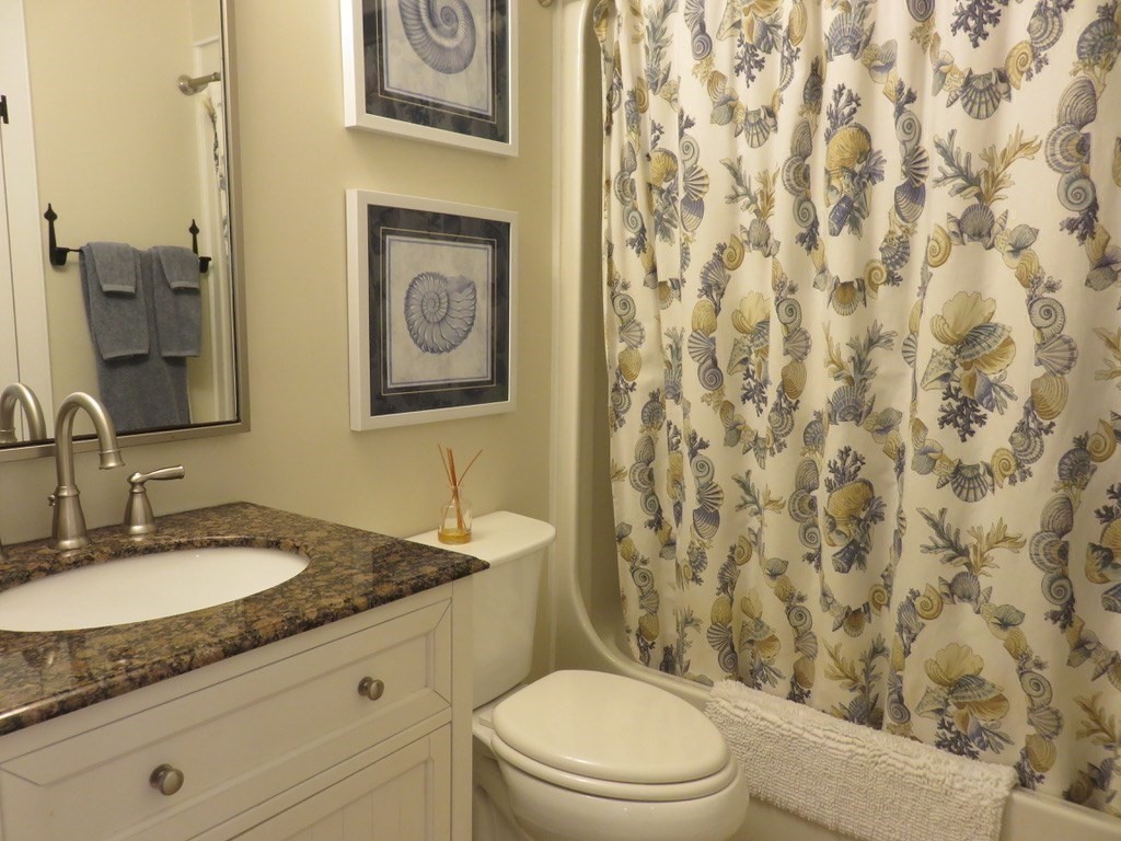 40 Brant Rock Road, Unit 40 Mashpee, MA 02649 - Photo 10 of 16 a bathroom with a granite countertop toilet sink and mirror