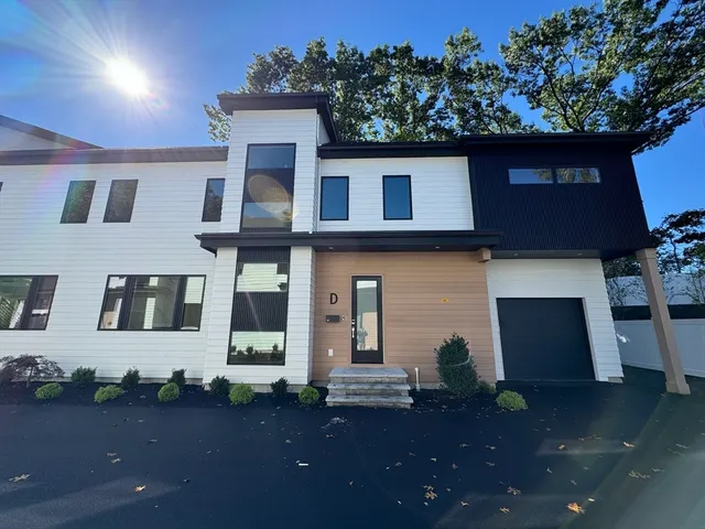 a front view of a house with lots of trees