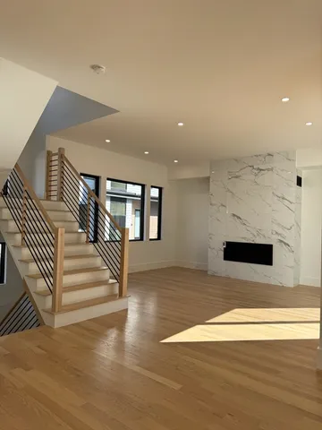 a view of entryway and hall with wooden floor