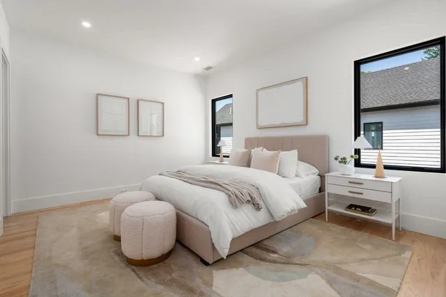 a bedroom with bed and a night stand