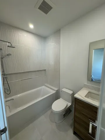 a bathroom with a toilet a sink and bathtub