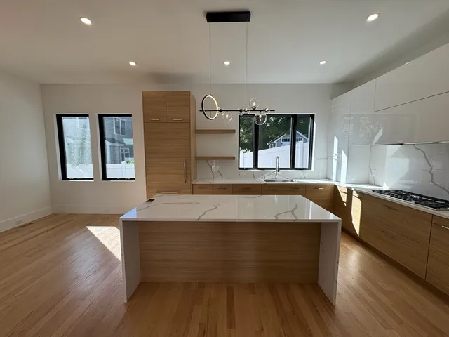 a spacious bathroom with a granite countertop sink and a large mirror
