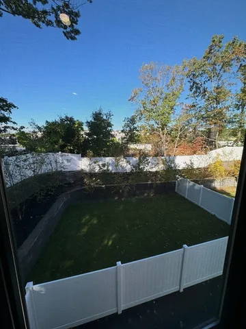 a view of yard with large trees