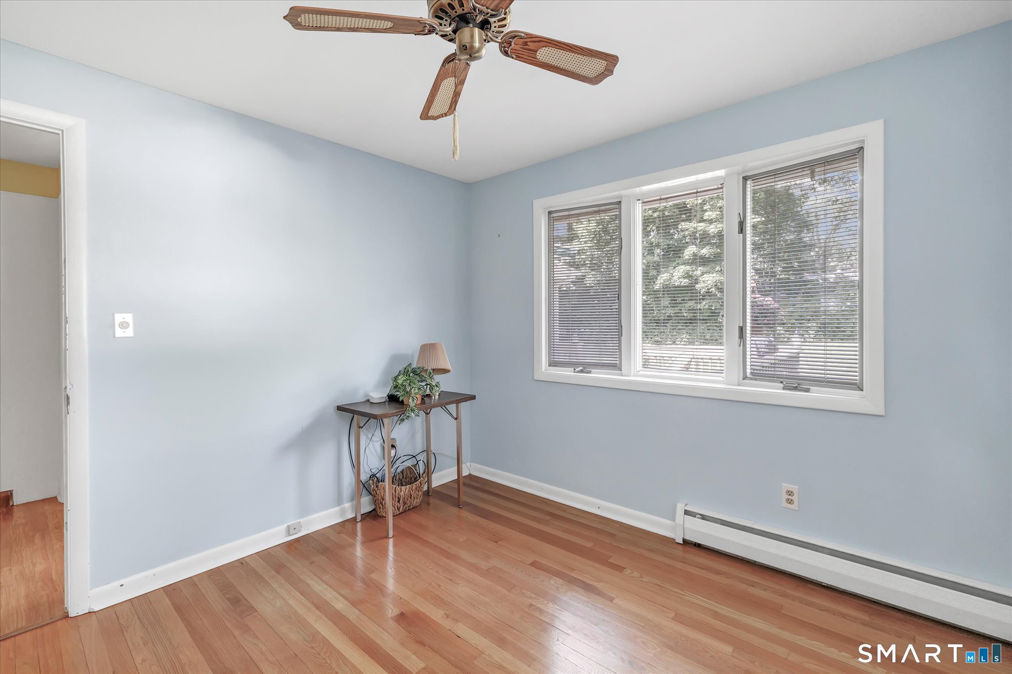 94 Ascolese Road Trumbull, CT 06611 - Photo 24 of 34 Bedroom can be perfect for a home office on main level hardwood flooring and ceiling fan, laundry area.