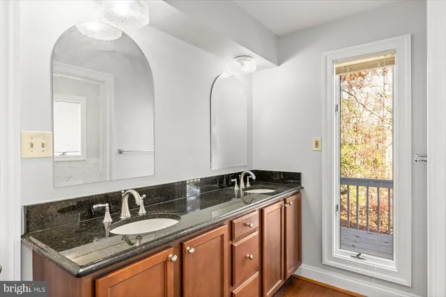 a bathroom with double sink and a mirror