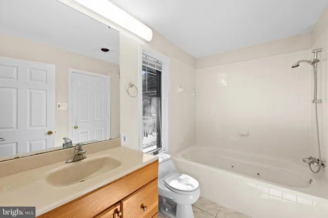 a bathroom with a sink a toilet and bathtub