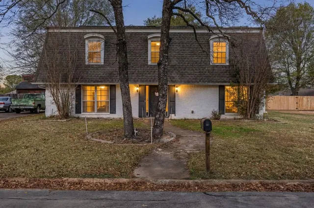 a view of a brick house with many windows