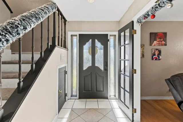 a view of entryway with wooden floor and a front door