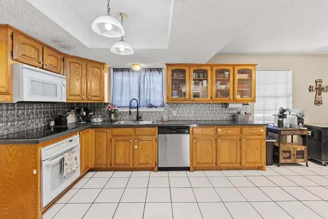 a kitchen with stainless steel appliances granite countertop a sink and cabinets