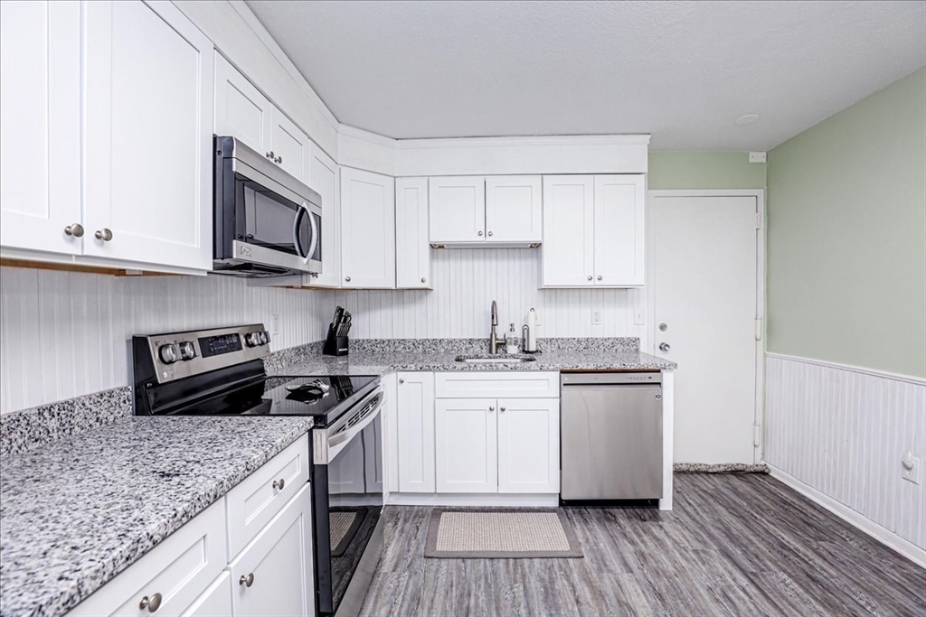 402 Paradise Road, Unit PHJ Swampscott, MA 01907 - Photo 15 of 27 a kitchen with stainless steel appliances granite countertop a stove a sink and a microwave