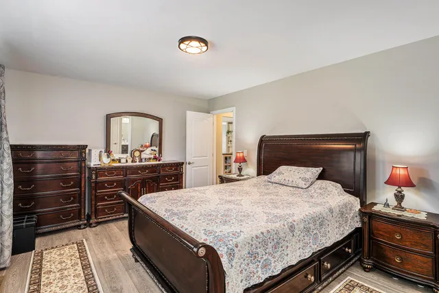 a bedroom with a bed and a dresser