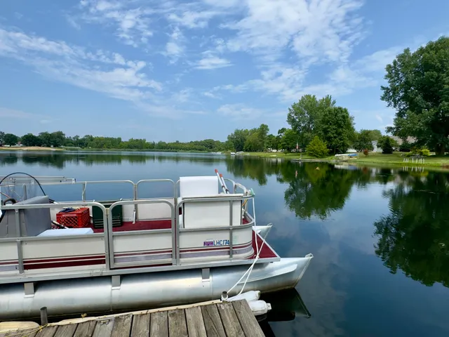 a view of a lake with couches in the patio