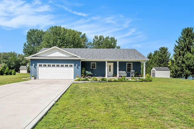 a front view of a house with a yard and porch